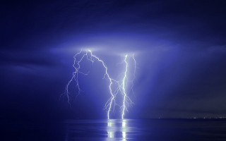 Lightning strikes water night dark - over a body of water free wallpaper