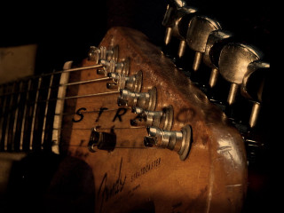 Guitar closeup black background abstract - a close up of a guitar free wallpaper