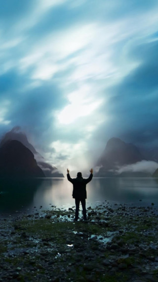 Man beach arms up mountains - a matte painting free wallpaper
