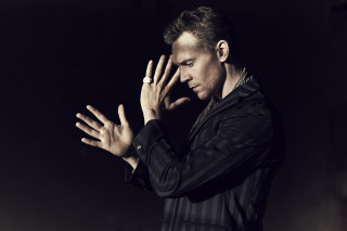 Man black shirt hands together - dramatic free wallpaper