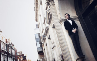 Man leaning building arms crossed - decadent free wallpaper