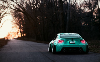 Green car sunset trees fence - rim free wallpaper