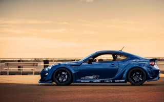 Blue sports car road fence 3 - widescreen free wallpaper