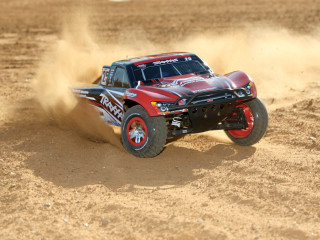 Red truck driving dirt sand - dust free wallpaper