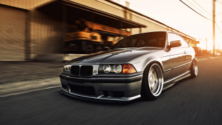 Black car driving street building - refined free wallpaper