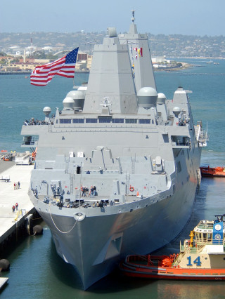 Large ship docked with flag - the water free wallpaper
