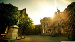 Large building clock tower courtyard 3 - a clock tower in the middle of its free wallpaper