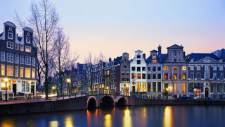 Bridge river buildings dusk amsterdam - a bridge over a river free wallpaper