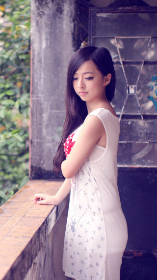 Woman standing ledged serious look - a ledge free wallpaper