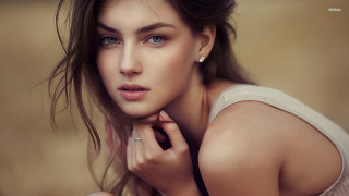 Woman ring pose brown background - her finger free wallpaper