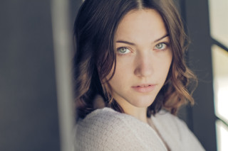 Woman blue eyes serious look 2 - her face and shoulder free wallpaper