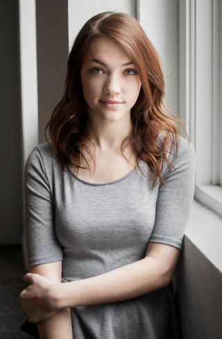 Woman posing window arms crossed - a serious look free wallpaper