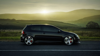 Black car sunset mountains field 2 - a black car free wallpaper