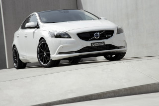 White volvo car parked building - a concrete wall behind free wallpaper
