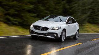 White volvo car driving road - a forest of trees and bushes free wallpaper