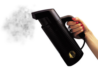Woman holding black blow dryer - steam free wallpaper