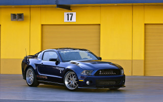 Blue mustang parked yellow building - a yellow building free wallpaper