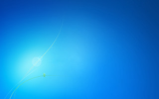 Blue sky green kite flying 2 - a person holding free wallpaper