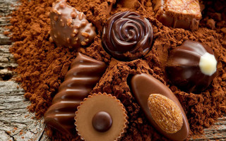 Chocolates dirt wooden table candle 2 - decadent free wallpaper