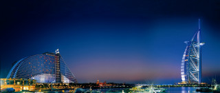 Tall building water night boats - the water below free wallpaper