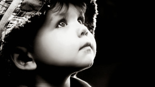 Young boy hat looking up - his eye wide open free wallpaper