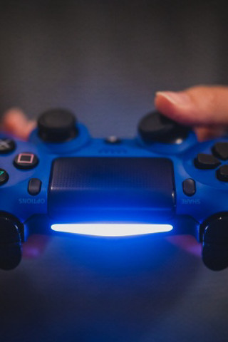 Person holding blue controller light - a person holding free wallpaper