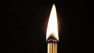 Matchstick lit dark flame between - a matchstick free wallpaper