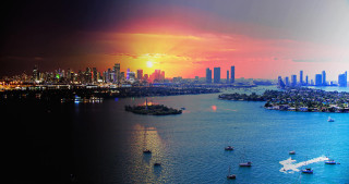 City skyline sunset water boats - a city skyline in the background free wallpaper