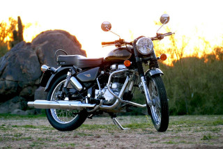 Motorcycle parked field rock sunset - a rock in the background free wallpaper