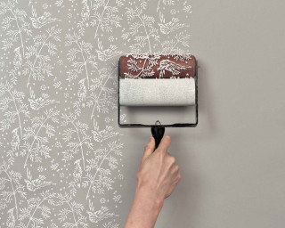 Person painting wall flower pattern - brush stroke free wallpaper