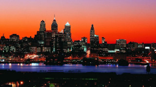 City skyline night orange sky 2 - a boat in the foreground free wallpaper