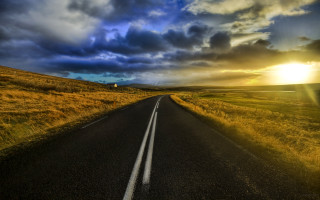 Clouds sunshine road grassy landscape - a grassy field below free wallpaper