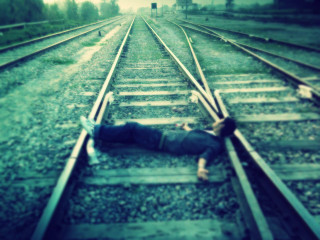 Man laying train tracks head - vfx free wallpaper