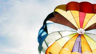 Colorful kite flying blue sky - a blue sky background free wallpaper