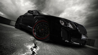 Black car red rims cloudy - a black car free wallpaper