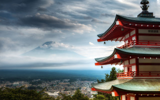 Tall red building mountain background - a mountain in the distance free wallpaper