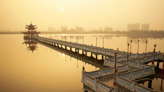 Bridge water building yellow sky - a building in the background free wallpaper