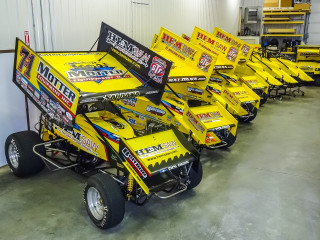 Yellow race cars garage white - a white wall behind them free wallpaper