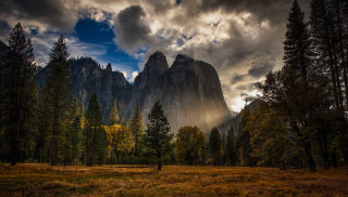 Man field mountain trees clouds - the background and a sunbeam free wallpaper