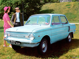 Man woman car field grass 2 - a hill in the background free wallpaper