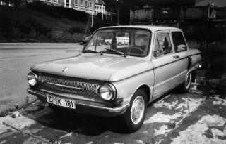 Small car parked road building - viennese actionism free wallpaper