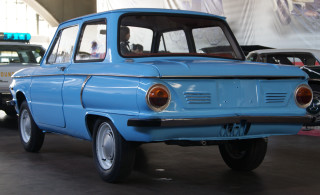 Blue police car garage retrofuturism - front view free wallpaper