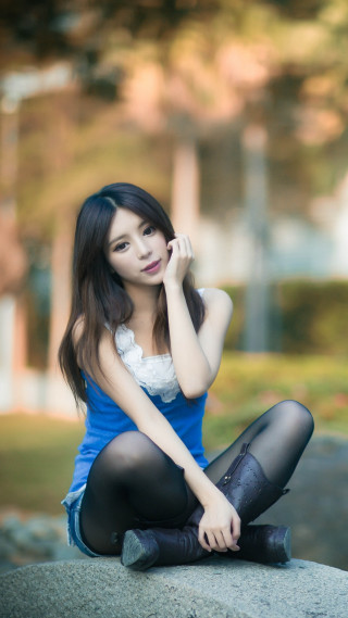 Woman sitting rock legs crossed - a rock free wallpaper