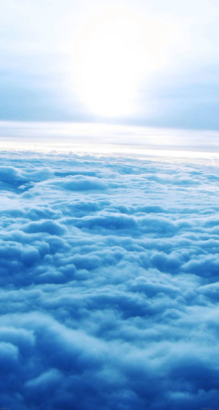 Sky view plane window clouds 2 - a bright sun in the distance free wallpaper