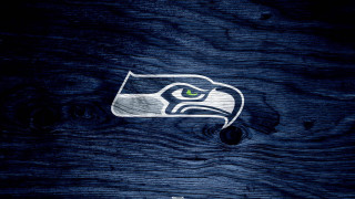 Seattle football logo green eye - a wooden surface free wallpaper