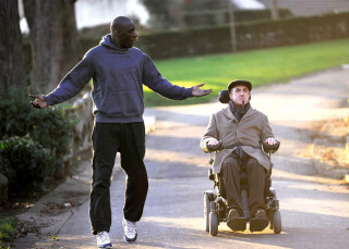 Man pushing wheelchair woman street - bernard accama free wallpaper