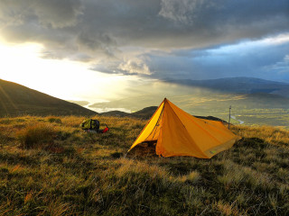 Tent grassy hill cloudy sky - a tent free wallpaper