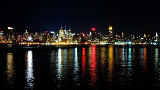 City skyline night lights reflection 8 - the water and a bridge in the foreground free wallpaper