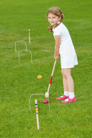 Girl hitting ball garden outdoors - a little girl free wallpaper