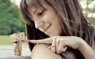 Woman holding wooden toy figure 2 - small free wallpaper